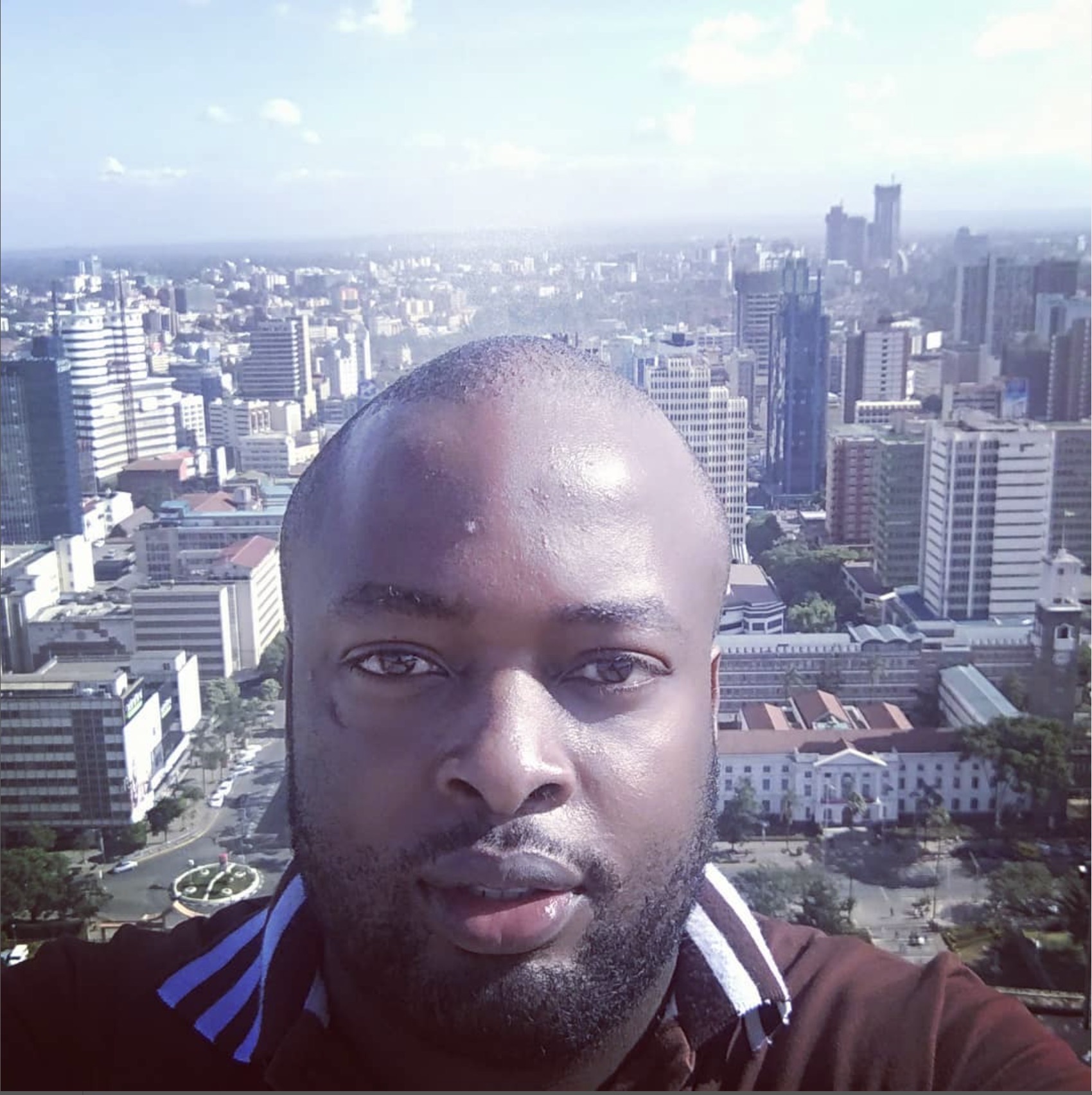 Portrait of Ken Isiaho with Nairobi skyline in the background
